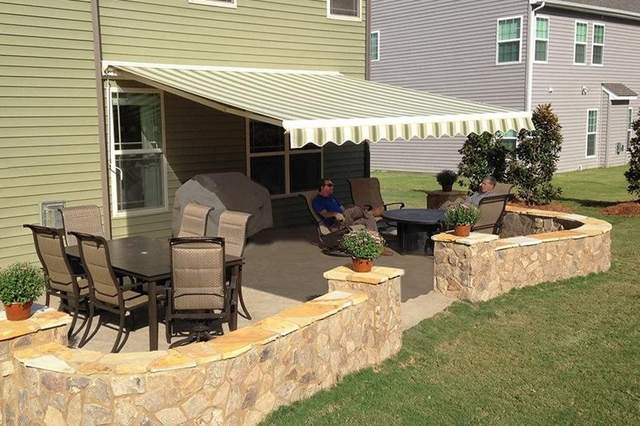 Homeowners relaxing under an installed awning
